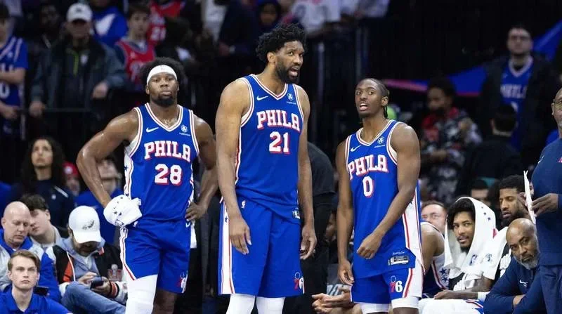 Feb 20, 2025; Philadelphia, Pennsylvania, USA; Philadelphia 76ers center Joel Embiid (21) and guard Tyrese Maxey (0) talk in the final minute of the fourth quarter against the Boston Celtics at Wells Fargo Center. Mandatory Credit: Bill Streicher-Imagn Images